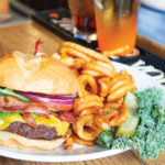 Glenwood's best doc holliday hamburger, with lettuce, tomato, pickle and a side of curly fries