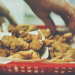 A red basket full of fried Rocky Mountain Oysters